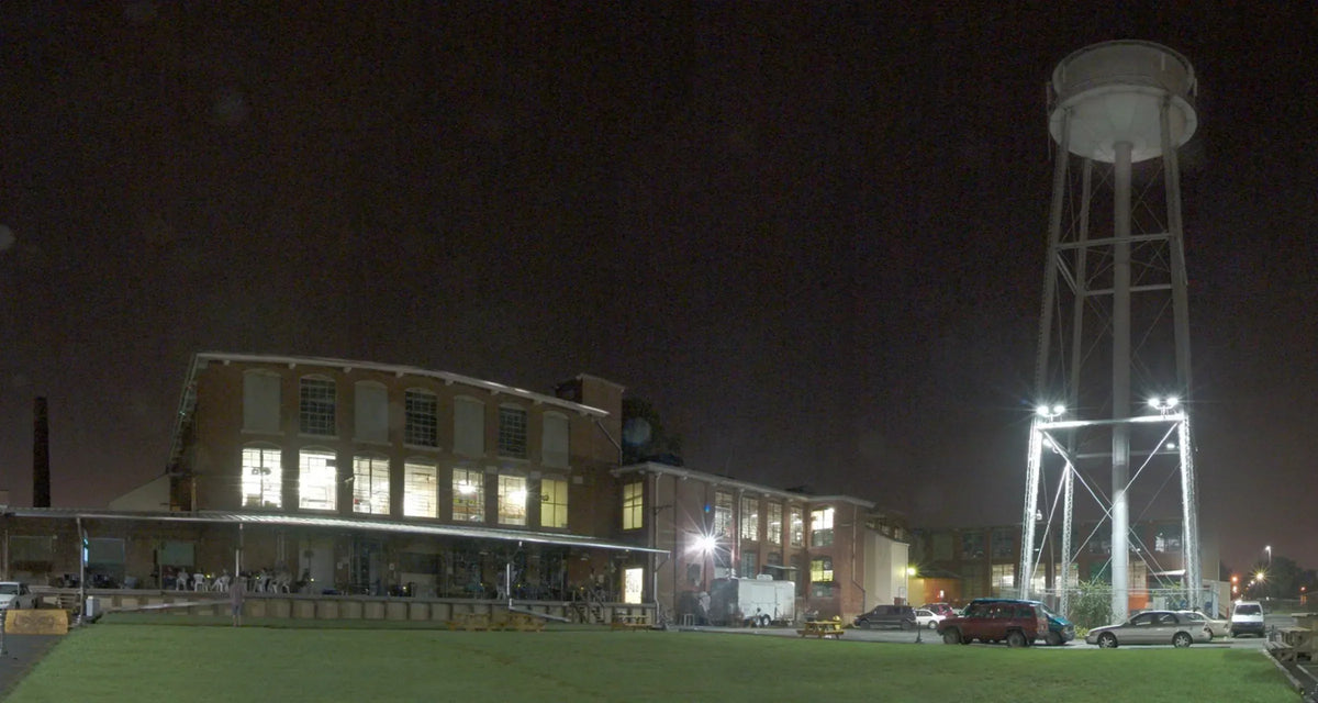Lowe Mill’s illuminated brick buildings at night in Huntsville